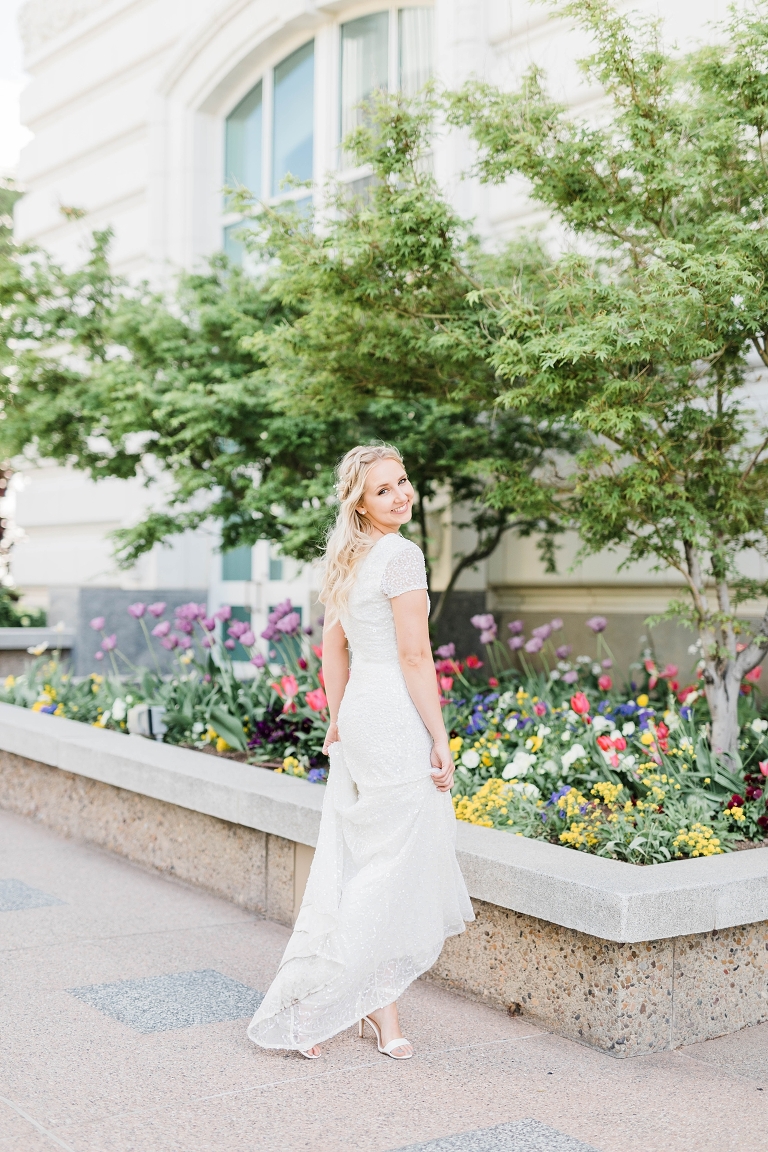 Salt Lake Temple Spring Wedding, Utah wedding photography, bride with modest wedding dress and long hairstyle, spring flowers