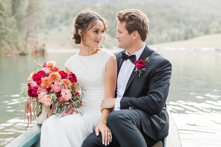 Tibble Fork Reservoir Couple in a Canoe, Utah Wedding Photography, Bride and Groom on lake, bright pink bouquet