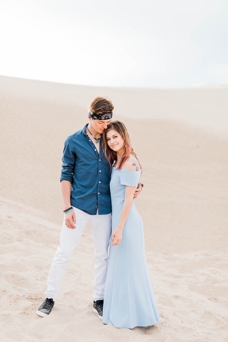 engagement photos at Little Sahara sand dunes Utah engagement photography, blue maxi dress summer outfits, what to wear for engagement photos, road trip questions for couples