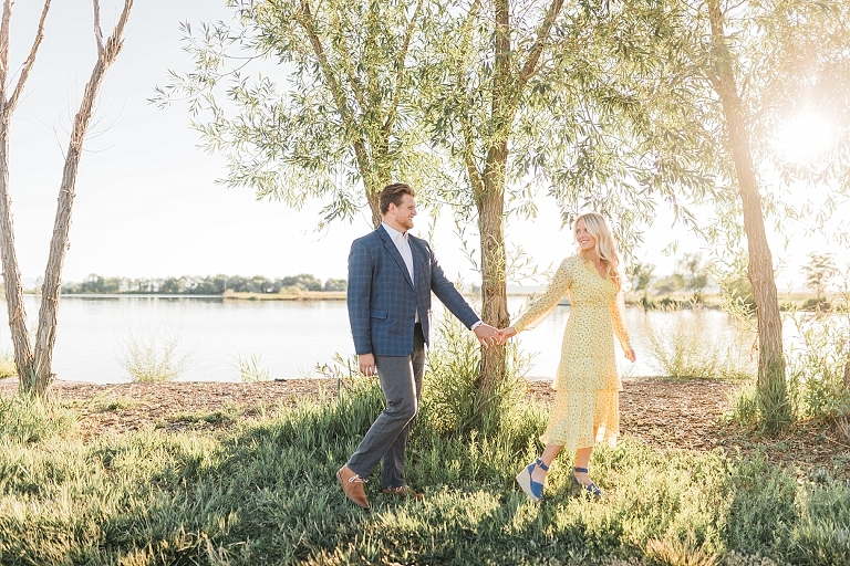 Bountiful pond couples session, flowing yellow dress and blue high heels, Pinstripe jacket and suit pants, Photography by Tasha Rose, Utah couples photographer